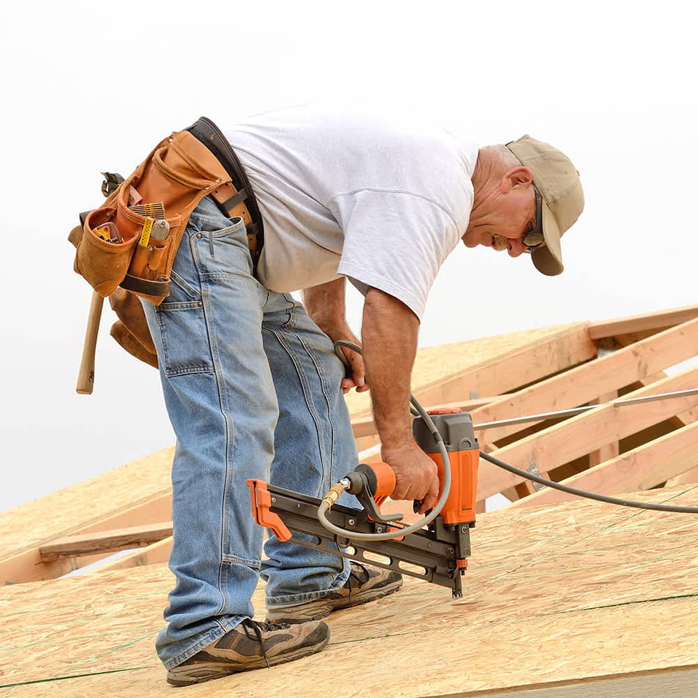 A roofer working on a roof