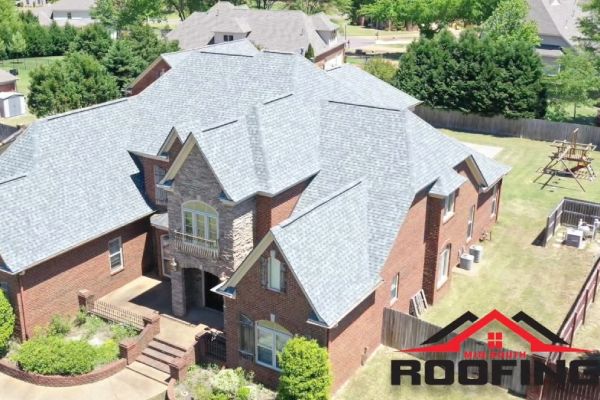 A large brick house with a blue roof.